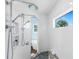 This walk-in shower offers a dual shower head system and a built-in shower bench at 9240 Pine Cove Dr, Englewood, FL 34224