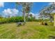 A large backyard with grass, a dining table and plants at 11247 Euler Ave, Englewood, FL 34224