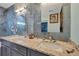 Bathroom featuring double vanity, granite countertops, framed mirror and beautiful tiled walls at 11247 Euler Ave, Englewood, FL 34224