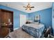Bedroom with nautical themed comforter, ceiling fan, and dark blue walls at 11247 Euler Ave, Englewood, FL 34224
