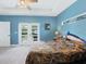 Bright bedroom featuring a tray ceiling, exterior door and a window at 11247 Euler Ave, Englewood, FL 34224