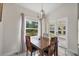 Bright dining area with marble style floors featuring access to the outdoors at 11247 Euler Ave, Englewood, FL 34224