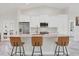 Bright kitchen with granite counters, stainless appliances, white cabinets, and marble flooring at 11247 Euler Ave, Englewood, FL 34224