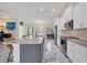 Spacious kitchen featuring white cabinets, granite countertops, and stainless steel appliances at 11247 Euler Ave, Englewood, FL 34224