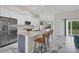 Bright kitchen with granite counters, stainless appliances, gray island, and marble flooring at 11247 Euler Ave, Englewood, FL 34224