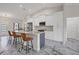 Spacious kitchen features granite counters, stainless appliances, gray island, and marble flooring at 11247 Euler Ave, Englewood, FL 34224