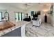 Open concept living area featuring tile floors, a comfortable sofa, and modern decor at 11247 Euler Ave, Englewood, FL 34224