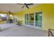 Covered patio with furniture, ceiling fans, and sliding glass doors to the interior of the home at 11247 Euler Ave, Englewood, FL 34224