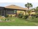 Spacious backyard with lush lawn, mature trees, and a black chain-link fence surrounding the perimeter at 170 Antilla Dr, Rotonda West, FL 33947
