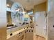 Chic bathroom featuring vanity with granite countertop, decorative glass, and a seamless glass shower enclosure at 170 Antilla Dr, Rotonda West, FL 33947