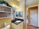 Well-lit bathroom featuring granite vanity top and decorative shelving for a clean and organized space at 170 Antilla Dr, Rotonda West, FL 33947
