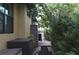 Landscaped walkway along the side of house, with lush greenery and palm trees, leading to an outdoor area at 170 Antilla Dr, Rotonda West, FL 33947