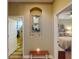 Inviting hallway featuring decorative mirror and a charming view into a bedroom and bathroom at 170 Antilla Dr, Rotonda West, FL 33947