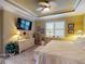 Stylish main bedroom showcasing tray ceilings, a ceiling fan, and a soothing color scheme for a tranquil retreat at 170 Antilla Dr, Rotonda West, FL 33947