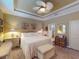 Comfortable main bedroom features tray ceiling, soft lighting, and stylish decor, creating a relaxing retreat at 170 Antilla Dr, Rotonda West, FL 33947