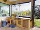 Outdoor kitchen featuring a stainless steel grill and scenic backyard views with palm trees at 170 Antilla Dr, Rotonda West, FL 33947