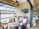 Outdoor patio area with a fireplace, seating area, and outdoor kitchen, perfect for entertaining by the pool at 170 Antilla Dr, Rotonda West, FL 33947