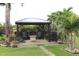 Backyard pavilion with patio furniture and landscaping providing a private outdoor living space at 170 Antilla Dr, Rotonda West, FL 33947