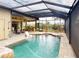 Enclosed pool area offers privacy with an outdoor kitchen and various seating options at 170 Antilla Dr, Rotonda West, FL 33947