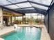 Enclosed pool area offers privacy with an outdoor kitchen and various seating options at 170 Antilla Dr, Rotonda West, FL 33947