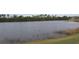 Scenic view of the tranquil pond from the home's property at 170 Antilla Dr, Rotonda West, FL 33947