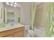 Bright bathroom features a single sink vanity and a shower/tub combination at 20211 Granlago Dr, Venice, FL 34293