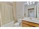 Well-lit bathroom with a shower-tub combo and a decorative shower curtain at 20211 Granlago Dr, Venice, FL 34293