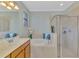 Well-lit bathroom features a soaking tub with a separate glass shower at 20211 Granlago Dr, Venice, FL 34293
