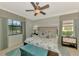 Well-lit bedroom features beautiful natural light, plush carpet, and a ceiling fan at 20211 Granlago Dr, Venice, FL 34293