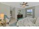 Bright bedroom featuring a large window with stunning water views and stylish decor at 20211 Granlago Dr, Venice, FL 34293