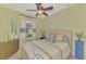 Charming bedroom boasts a ceiling fan, bright window, and an accent cabinet at 20211 Granlago Dr, Venice, FL 34293