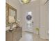 Inviting foyer with tile flooring, stylish décor, and a decorative mirror at 20211 Granlago Dr, Venice, FL 34293