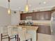 Kitchen with granite countertops, stainless steel appliances, and breakfast bar at 20211 Granlago Dr, Venice, FL 34293