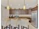 Kitchen boasts stainless steel appliances and a breakfast bar with seating for three at 20211 Granlago Dr, Venice, FL 34293