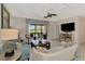 Comfortable living room featuring modern ceiling fan and sliding glass doors to a screened lanai at 20211 Granlago Dr, Venice, FL 34293