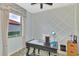 Bright office with a large window, desk, and grid patterned accent wall at 20211 Granlago Dr, Venice, FL 34293