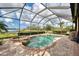Screened-in pool and spa area with a view of the lake and landscaping at 20211 Granlago Dr, Venice, FL 34293