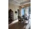 Elegant dining area with a rustic chandelier, stylish table setting, and access to the outdoor patio at 380 Hoffer St, Port Charlotte, FL 33953
