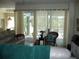 Inviting living room with neutral tones, sheer curtains filtering natural light, and a view of the outdoor pool area at 380 Hoffer St, Port Charlotte, FL 33953
