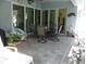 Outdoor patio with comfortable seating arrangements, tile flooring, and seamless access to the pool area and backyard at 380 Hoffer St, Port Charlotte, FL 33953