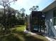 Enclosed pool area featuring a screened-in patio, providing a private and relaxing outdoor space with lush landscaping at 380 Hoffer St, Port Charlotte, FL 33953