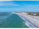 Stunning aerial view of a pristine beach with beachfront homes and turquoise waters at 396 N Gulf Blvd, Placida, FL 33946