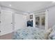 This bedroom has a coastal themed bed set, closet, and a sliding door to a deck area for enjoying the outdoors at 396 N Gulf Blvd, Placida, FL 33946