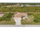 Expansive aerial view of the home showcasing its screened-in pool, landscaping, and neighborhood at 116 Hercules Dr, Rotonda West, FL 33947