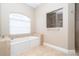 Inviting bathroom features a soaking tub under a decorative window and a glass shower at 116 Hercules Dr, Rotonda West, FL 33947