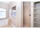 Bathroom showcases tub, natural lighting, and walk-in shower with decorative tile at 116 Hercules Dr, Rotonda West, FL 33947