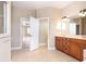 Spacious bathroom with a double sink vanity, walk-in shower, and an open doorway to bedroom at 116 Hercules Dr, Rotonda West, FL 33947