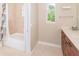 Bathroom with shower-tub combo, neutral tile, and a window providing natural light at 116 Hercules Dr, Rotonda West, FL 33947
