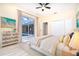 Well-lit bedroom featuring lanai access, neutral tones, and white closet doors at 116 Hercules Dr, Rotonda West, FL 33947