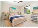 Comfortable bedroom with woven bed frame, cool coastal decor, and a serene, relaxing atmosphere at 116 Hercules Dr, Rotonda West, FL 33947